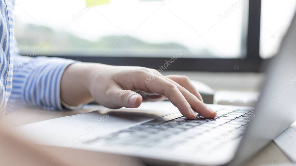 Businesswoman's hand presses on a laptop keyboard, World of technology and internet communication, Using computers to conduct financial transactions because the convenience and speed.