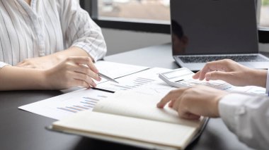 Brainstorm team, Marketers and financial accountants are discussing and analyzing charts to plan strategies to meet customer needs, Business data graph, Team meetings or business consulting.