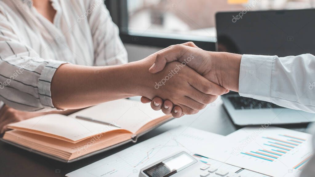 Business personage handshake, Asian businessman congratulate on being a corporate partnership with European woman investors, Friendship, Sign language greetings, Successful business negotiations.