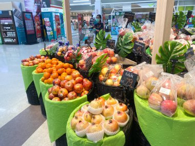 Tesco lotus, THAILAND- 25 Ağustos 2021: Çeşitli taze meyve ve sebzelerin rafları veya sepetleri tertipli, taze sebze veya meyve, organik gıda, Taylandlı insanlarla büyük süpermarket.
