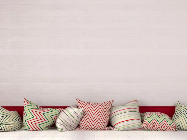 Colorful cushions near a white wooden wall — Stock Photo, Image