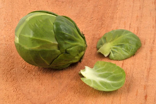 Raw Brussels Sprouts Leaves Close Wooden Background —  Fotos de Stock