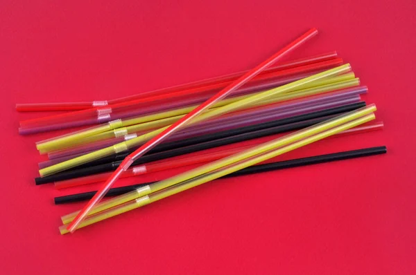 Plastic Straws Different Colors Close Red Background —  Fotos de Stock