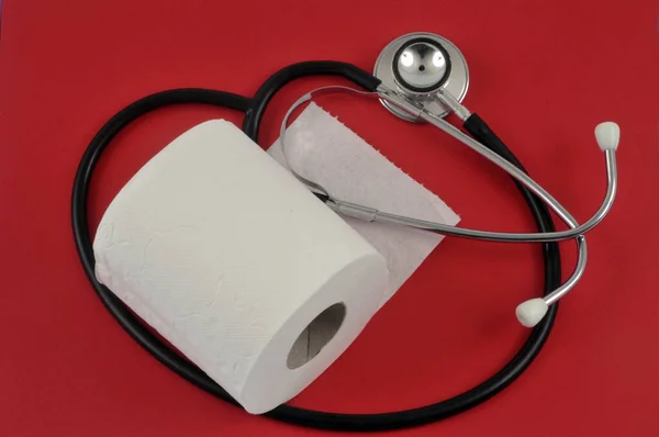 Constipation Concept Toilet Paper Roll Stethoscope Red Background — Stock Photo, Image