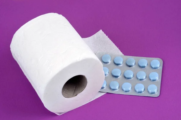 Constipation Concept Toilet Paper Roll Laxative Blister Pack Pink Background — Stock Photo, Image