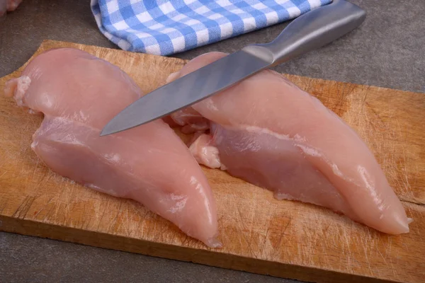 ナイフでまな板の上に生の鶏の切り身 — ストック写真
