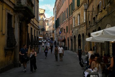 Eski Siena kentinde Pantaneto yoluyla gezinen turistler 