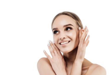 Close up on a white background with space for text. Smiling woman with fresh and healthy skin looking towards space for text.