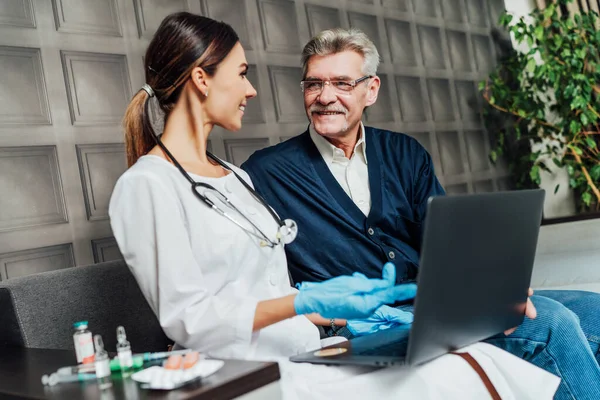 Una Enfermera Sonriente Comunica Con Paciente Viejo Muestra Sus Pruebas — Foto de Stock