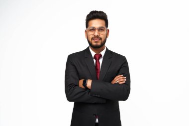 Portrait of young indian businessman with crossed arms on white isolated background.