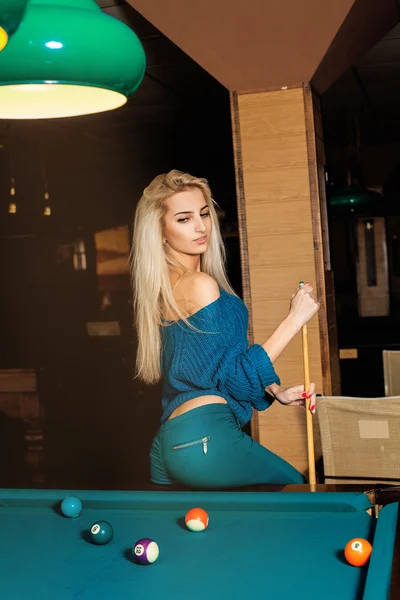 Vertical portrait of young fashionable girl posing on pool table — Stock Photo, Image