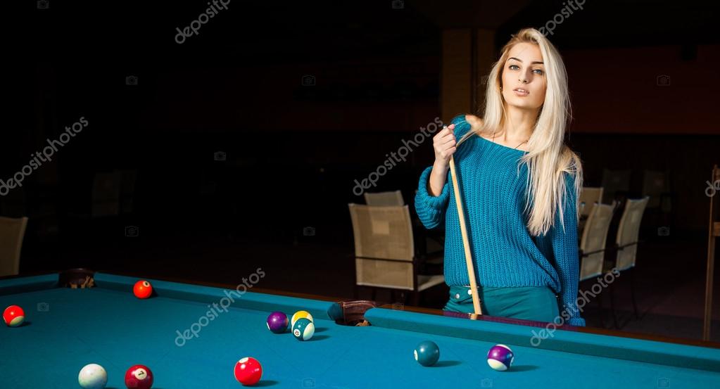 Fashion portrait of beautiful young blonde girl plays billiard Stock Photo  by ©ponomarencko 100223580