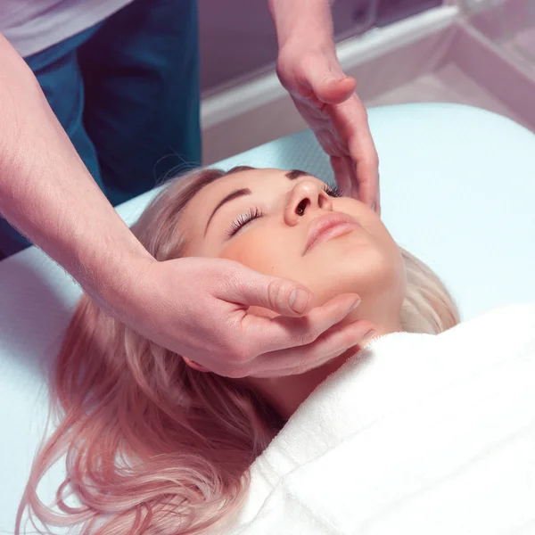 Square photo of Beautiful young woman receiving facial massage w — Φωτογραφία Αρχείου