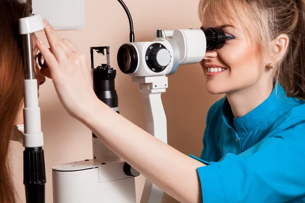 Atractiva oftalmóloga feliz mujer está trabajando en la clínica — Foto de Stock