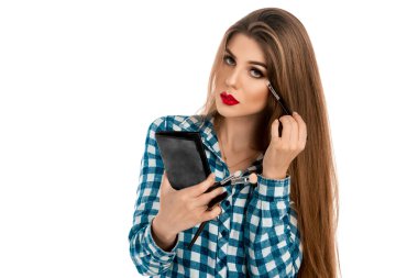 Woman in casual clothes makes a make-up