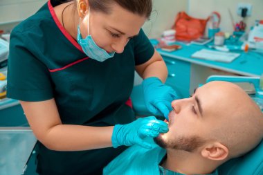 Portrait close up of male at the chekups teeth in dental office