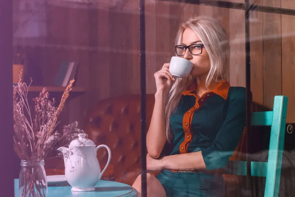 Elegant young blond business woman on a coffee break in a city c