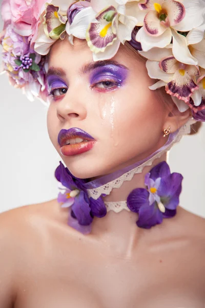 Sad young woman crying in studio — Stock Photo, Image