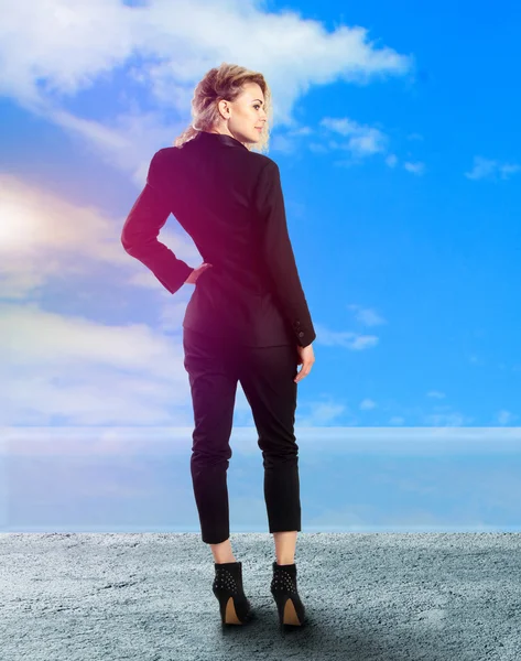 Blonde lady in black business suit on high heels — Stock Photo, Image