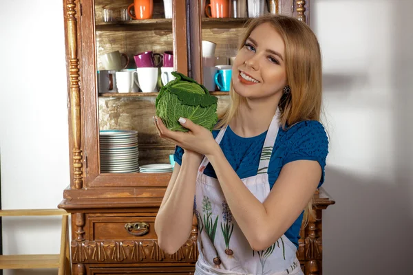 Girl chef with green cabbage in hands — Stock Photo, Image