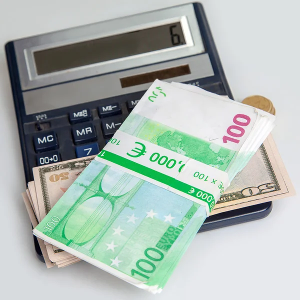 Square photo of moneys lie on a calculator — Stock Photo, Image