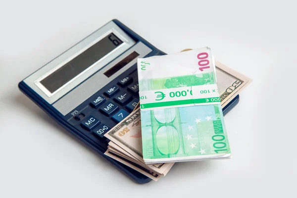 Euro money and dollars in bundles lie on the calculator — Stock Photo, Image