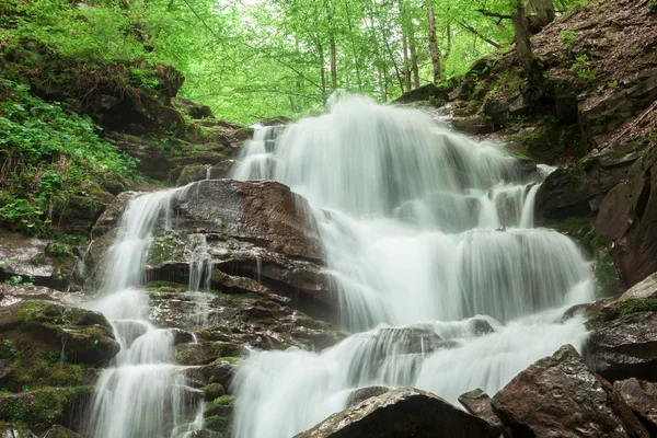 mountain waterfall with a rocky bottom
