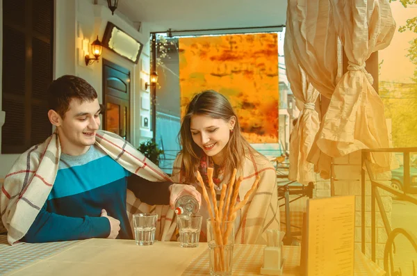 Beautiful couple on a date in a street cafe — Stock Photo, Image