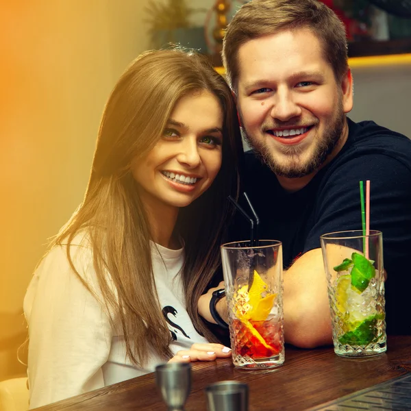 Square portrait of beautiful fashionable couple at the bar — Stock Photo, Image