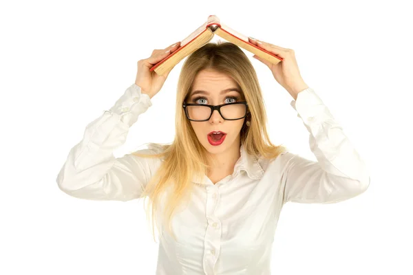 Girl in glasses holding a book above the head — Stock Photo, Image