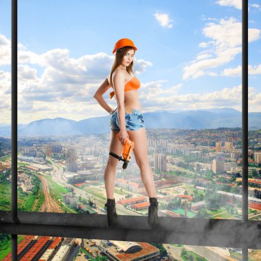 woman builder standing on a crossbar