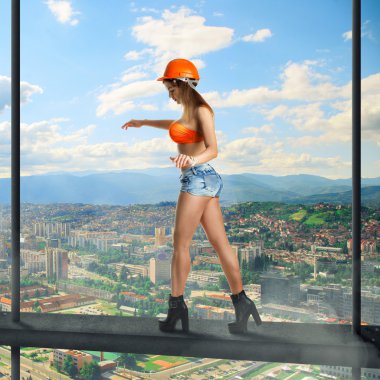 woman builder walks on a crossbar
