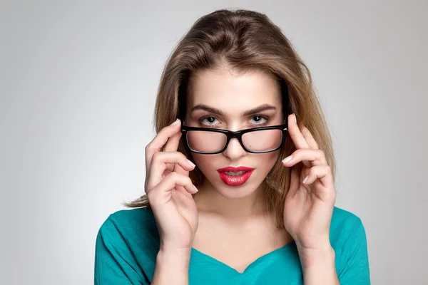 Serious woman in glasses and with red lips — Stock Photo, Image