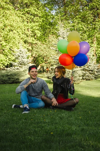 Couple sitting in a park on the lawn — Stock Photo, Image