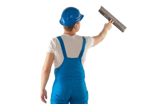 Man in blue uniform with putty knife — Stock Photo, Image