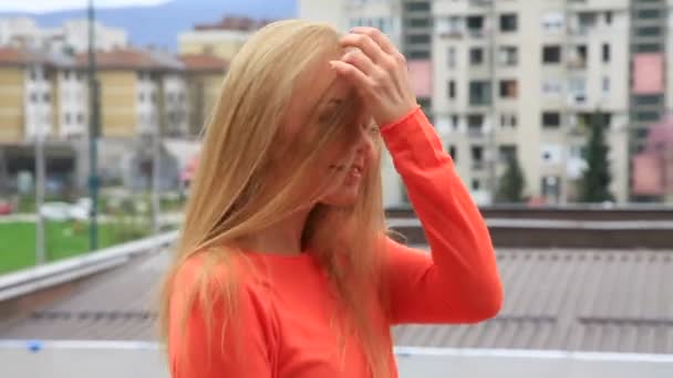 Молода блондинка посміхається на відкритому повітрі — стокове відео