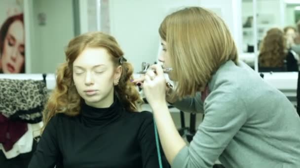 Donna mette un trucco ad una bella ragazza — Video Stock