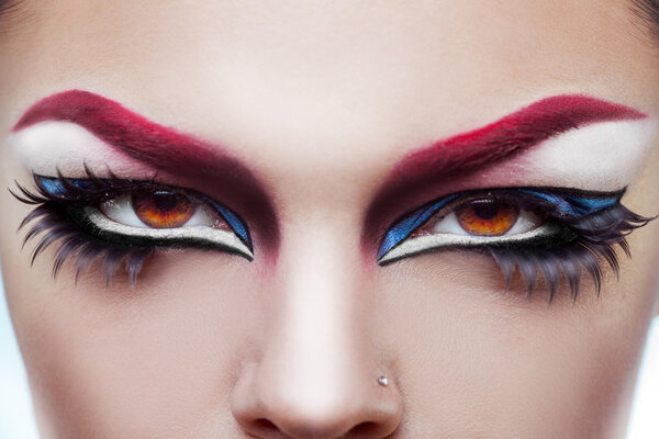 Close up photo of womans eyes with make up and healthy skin