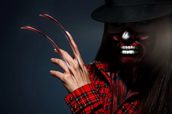 Scary halloween portrait of female with knifes in hand — Stock Photo, Image