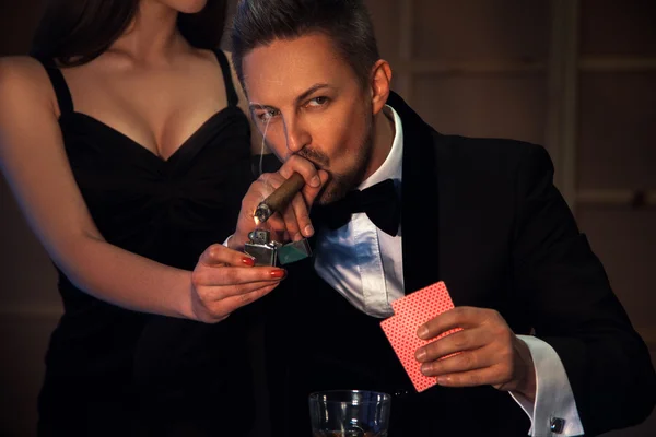 Sexy man smoking cigar and playing cards — Stock Photo, Image