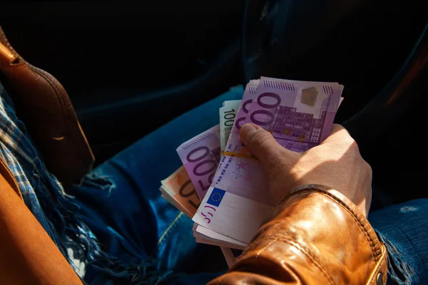 Close-up photo of male hand holding a wads of money — Stock Photo, Image