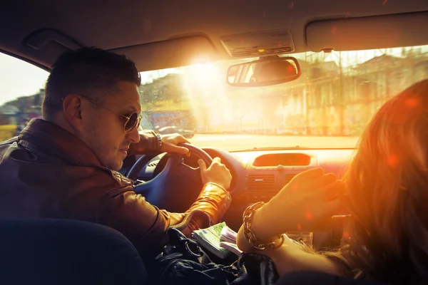 Attractive man driving car and look at his girl — Stock Photo, Image