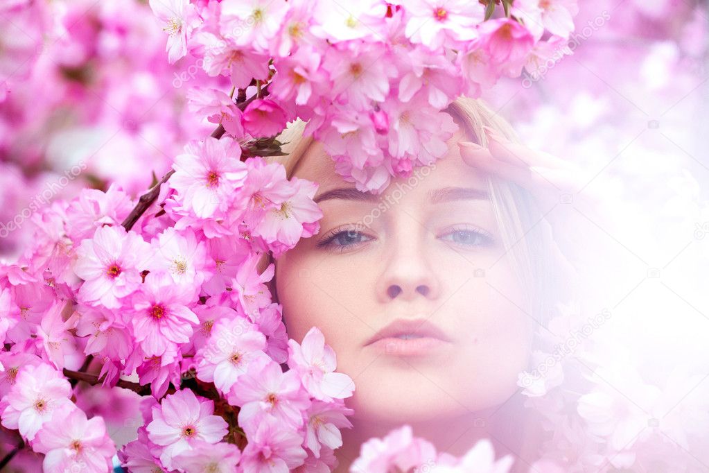 Stunning young blonde in bright pink flowers