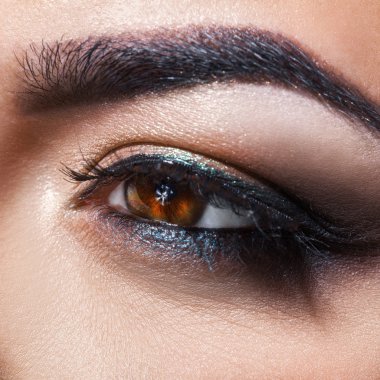 Macro square photo of brown woman eye looking away