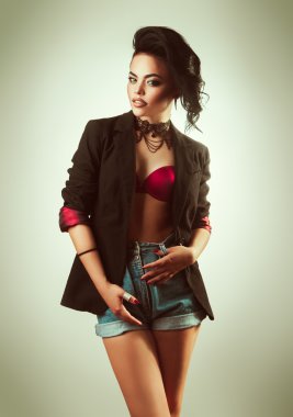 Caucasian adult brunette with make up and hairstyle looking at camera