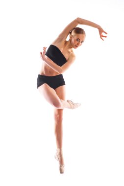 Pretty ballerina posing pn white background in training suit