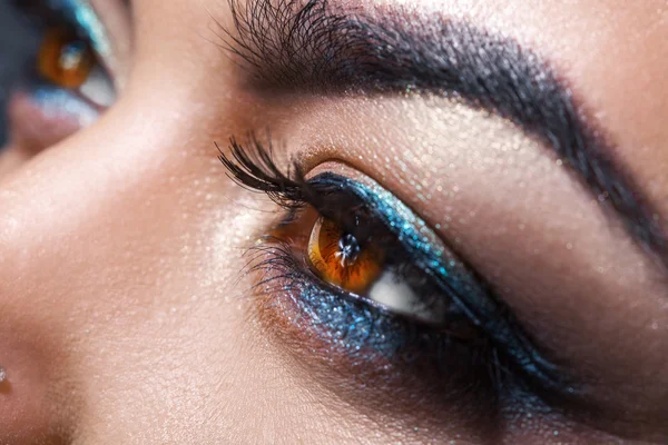 Female brown eyes looking away with make up. Macro photo — Stockfoto