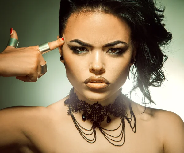 Beautiful adult brunette looking at camera with make up and hair — Stock Photo, Image