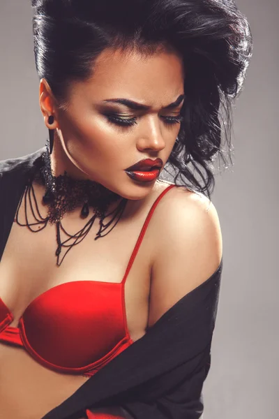 Sexy adult woman with closed eyes and make up in red bra — Stock Photo, Image