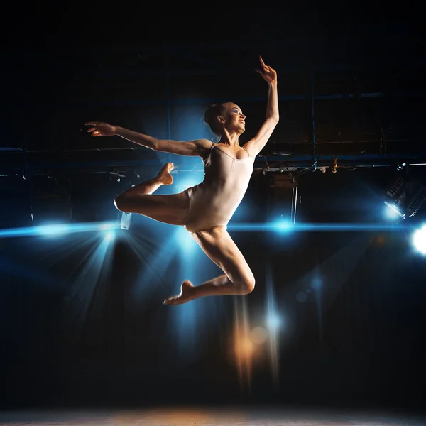 Square photo of young blonde ballet dancer in jump on stage — 图库照片